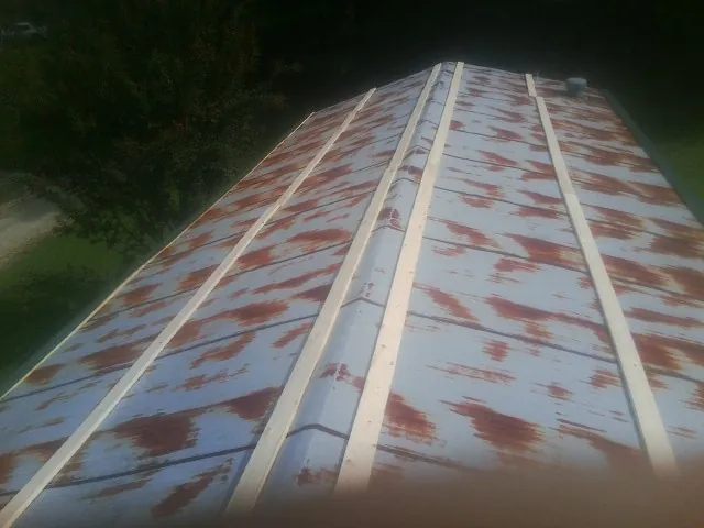 Rusted metal roof panels with new wood purlins before replacement — Storm Damage Roof Repair in Eola by Roofing Brothers